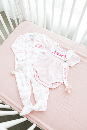 Personalized baby set featuring a pink monogrammed footie and a matching pink gingham romper