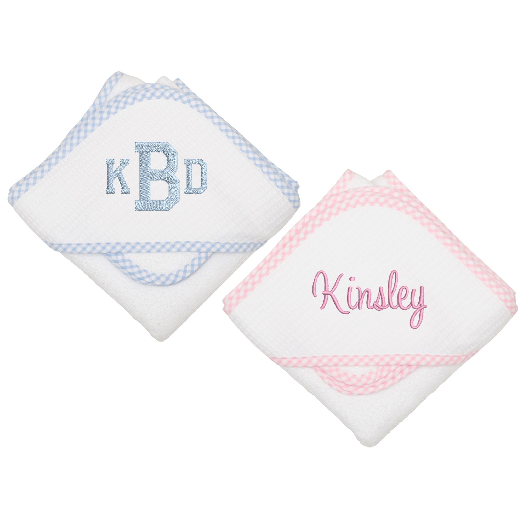 Two white hooded towels: a light blue gingham trim with 'KBD' and a pink gingham trim.