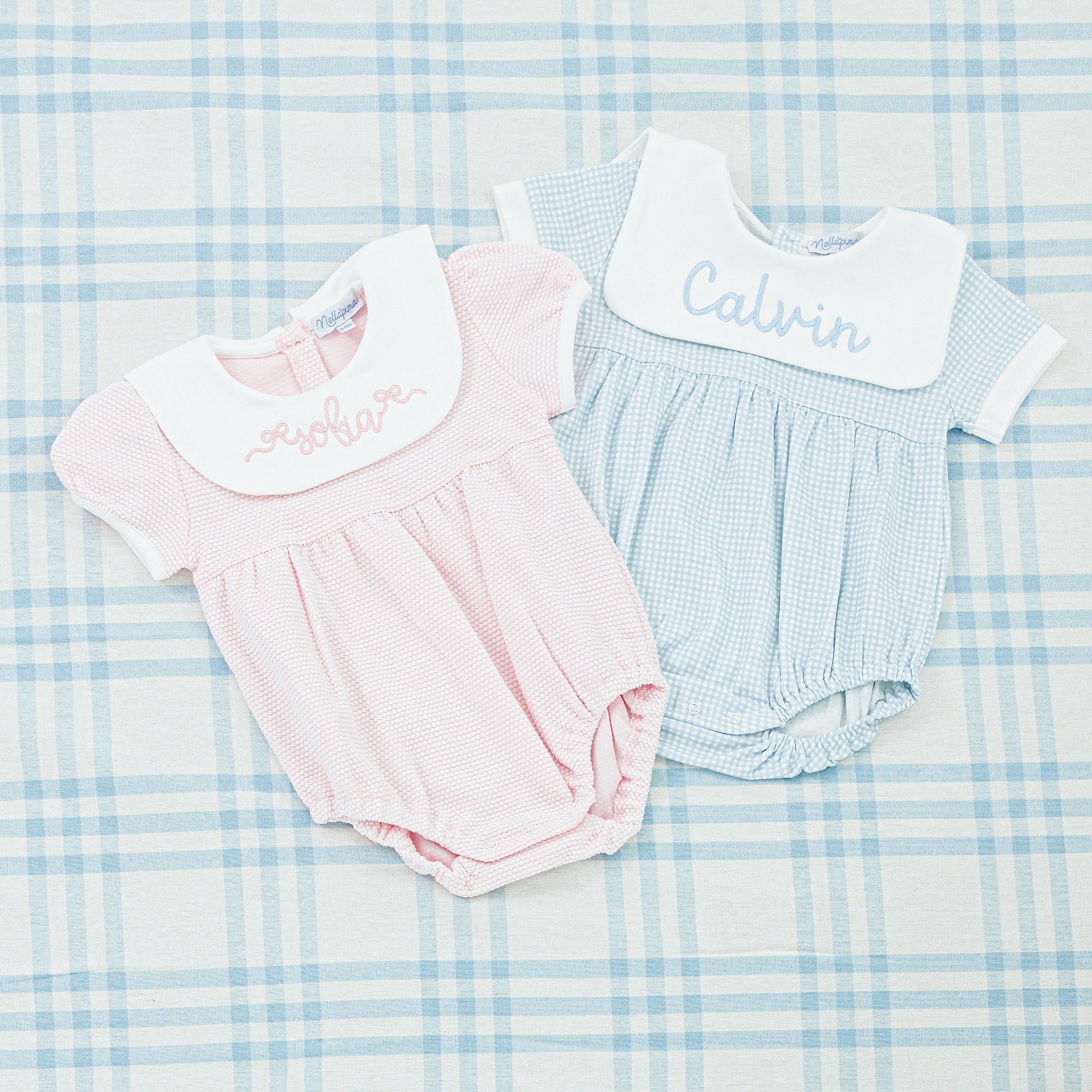 Two seersucker baby outfits with personalized embroidery