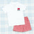 Two white polo shirts with personalized embroidery