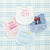 Two personalized bibs: a blue gingham bib with a cowboy hat and a pink gingham bib with tulips.