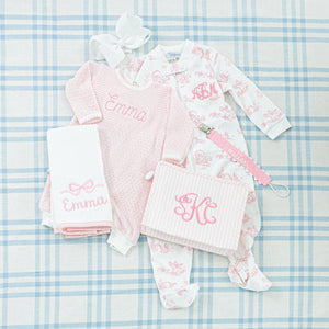 A personalized baby gift set featuring a pink theme.