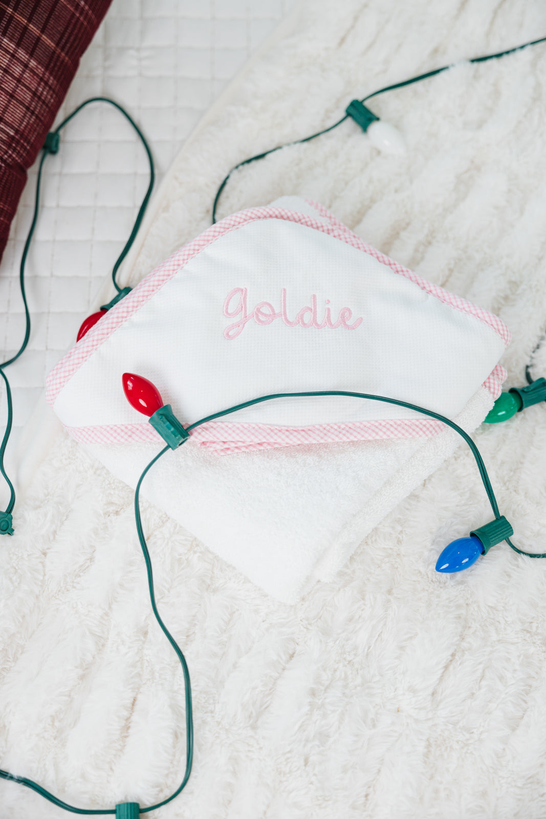 Two white hooded towels: a light blue gingham trim with 'KBD' and a pink gingham trim.