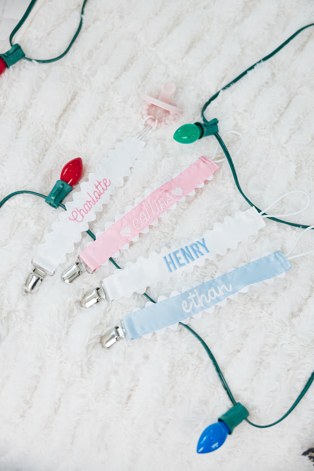 Set of three pastel-colored pacifier clips with rickrack trim.