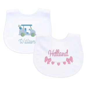 White baby bibs with delicate trim details and motif.