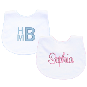 White baby bibs with delicate trim details, designed for comfort and easy cleaning.