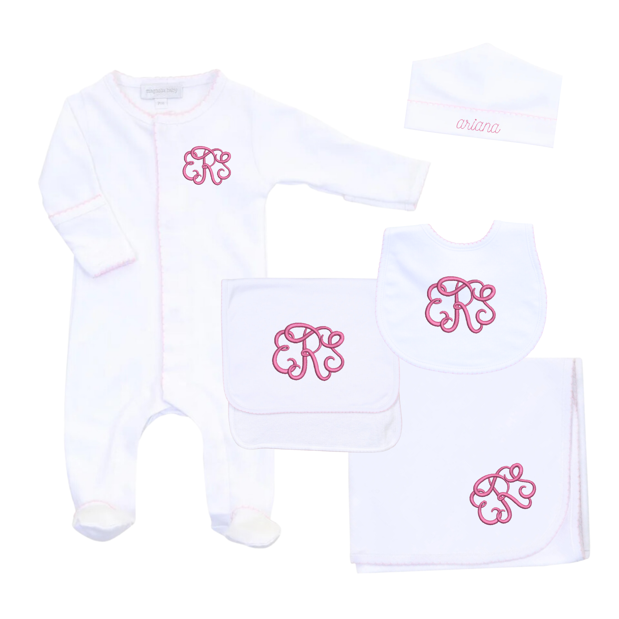 White baby gift set featuring a onesie, hat, bib, burp cloth, and blanket, all accented with pink trim