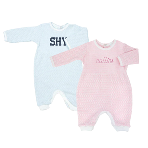 Two baby onesies, one in light blue and the other in light pink, both long-sleeved