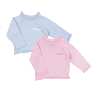 Pink and blue baby sweater personalized with the name.