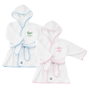 Two soft, hooded baby robes with contrast piping and belt closure with embroidered motif.